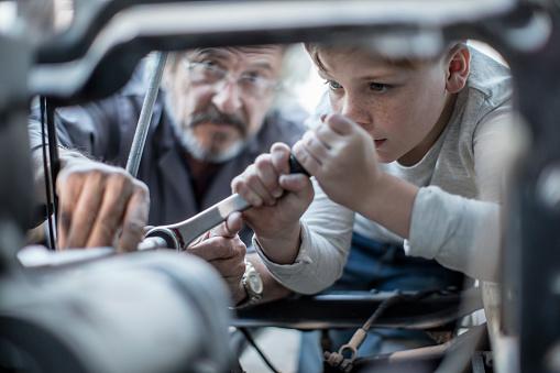 Child fixing a car